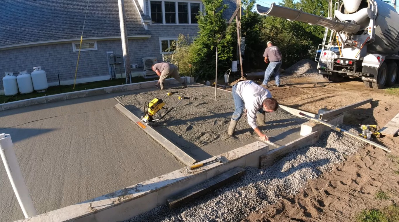 Professional concrete contractors pouring and finishing concrete for residential project in New Albany, IN